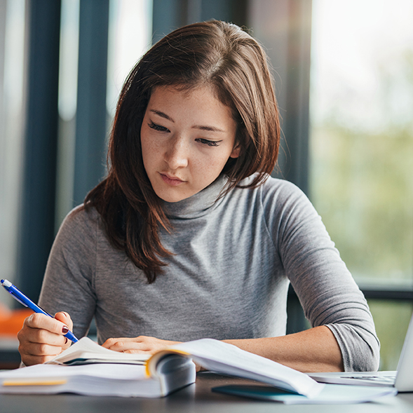 Woman studying looking over a book