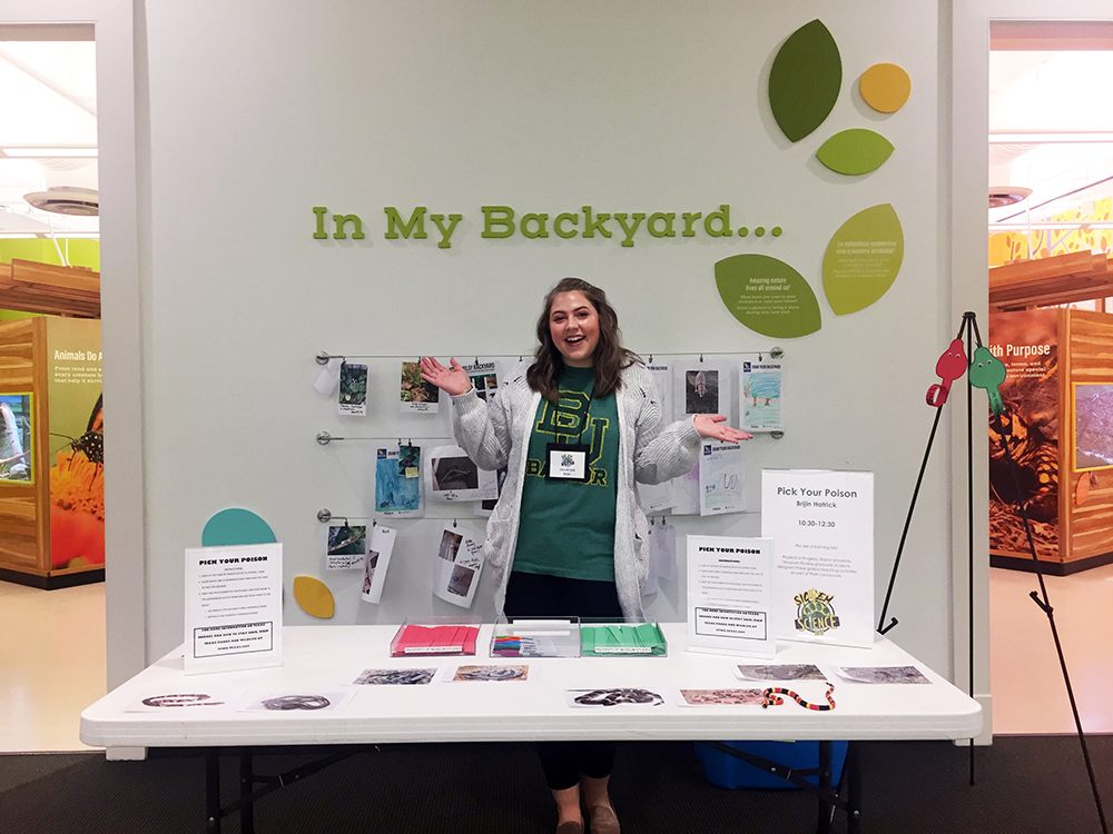 Recent graduate Brijin Hartrick posing at a desk at Baylor University